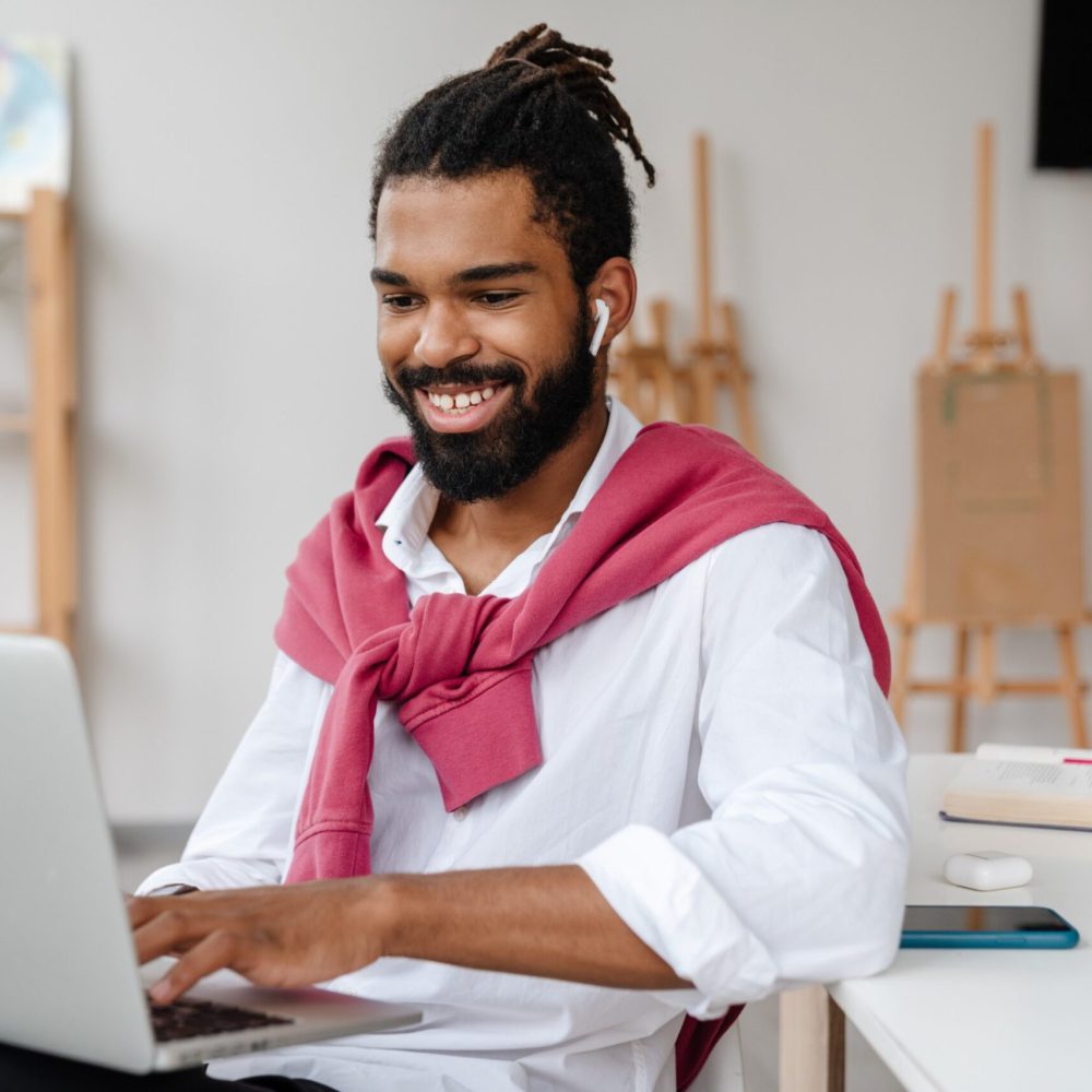 happy-african-american-guy-in-earphones-working-wi-2023-11-27-05-36-23--scaled.jpg